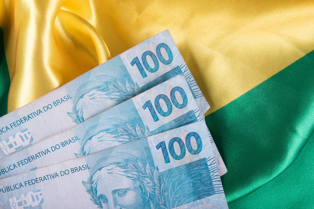 One hundred reais notes on Brazilian flag